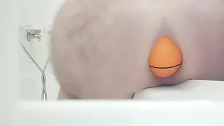 Huge 12cm wide soccer ball slides get a kick from my ass at bottom side of bath.